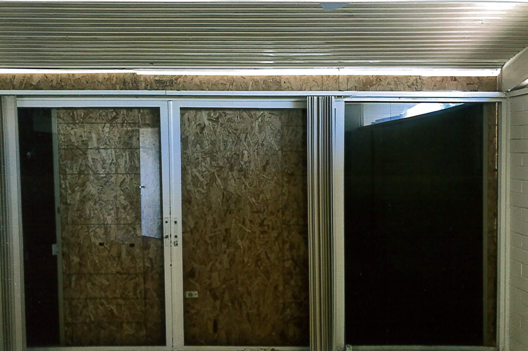Livingroom, sliding doors have been boarded over